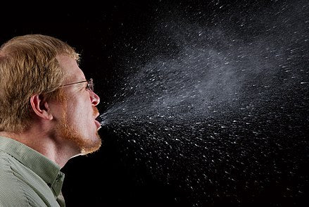 Man coughing and spraying germs